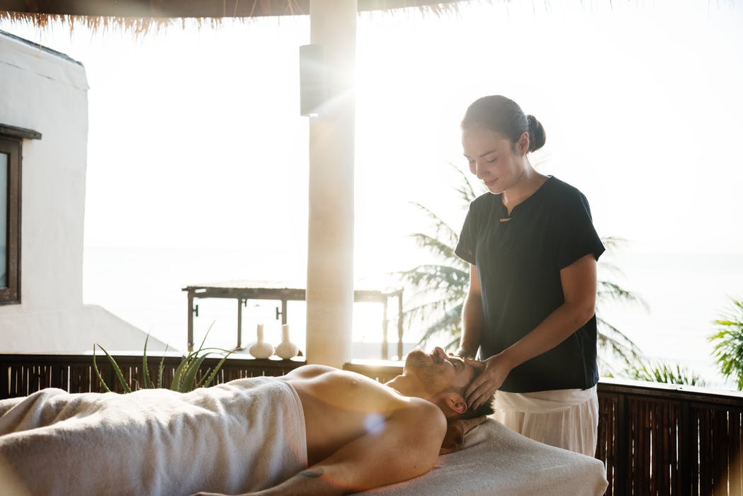 man getting a head massage in a spa